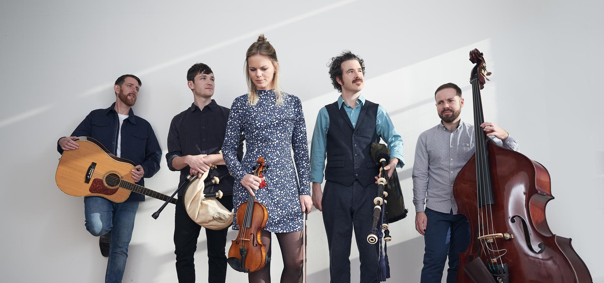 Group of Celtic musicians posing with their instruments.