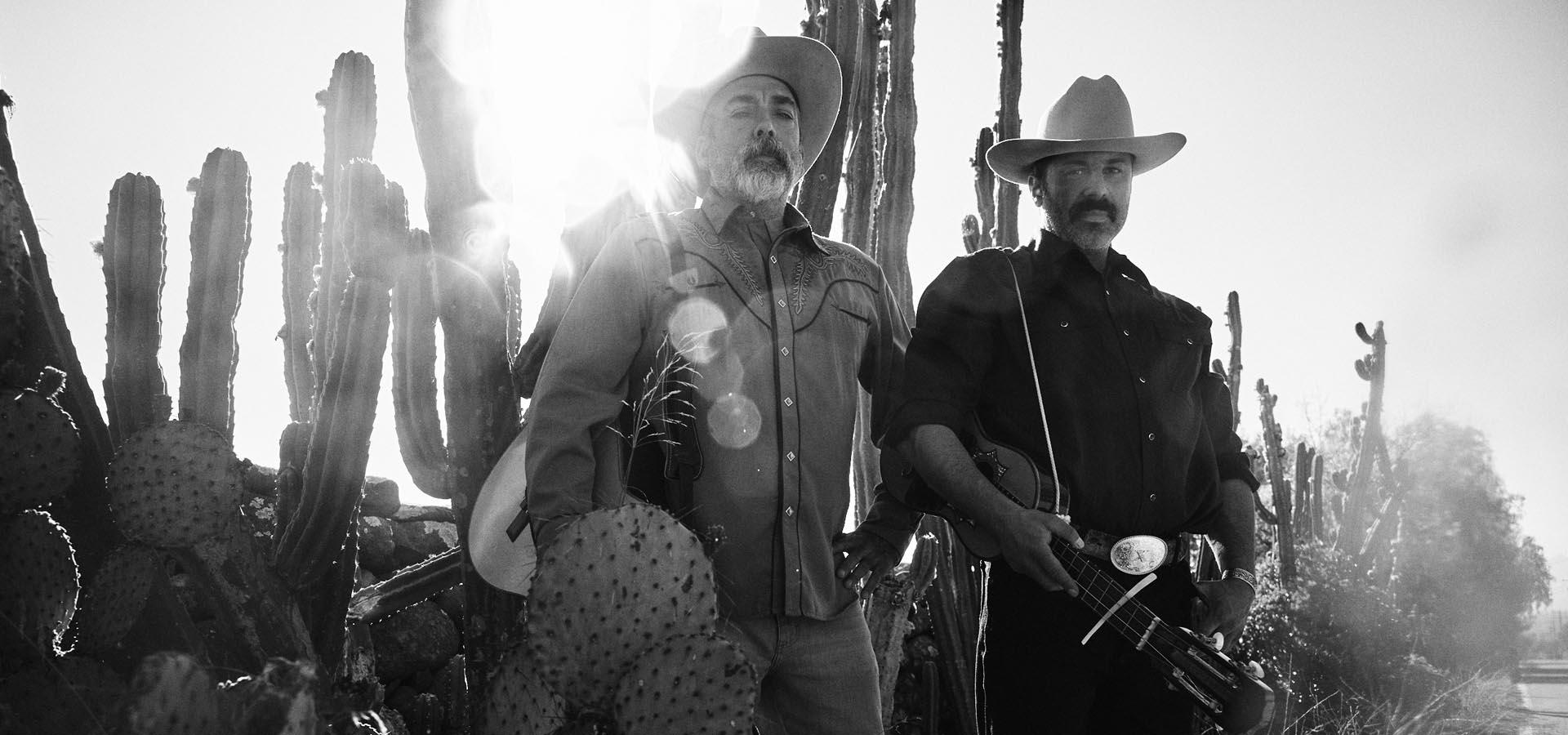 A pair of musicians posing in the desert.